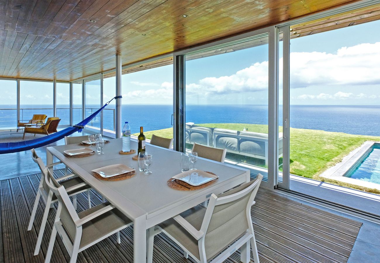Bright dining area opening onto the terrace, pool, and ocean at Villa Karuka, Trois-Rivières
