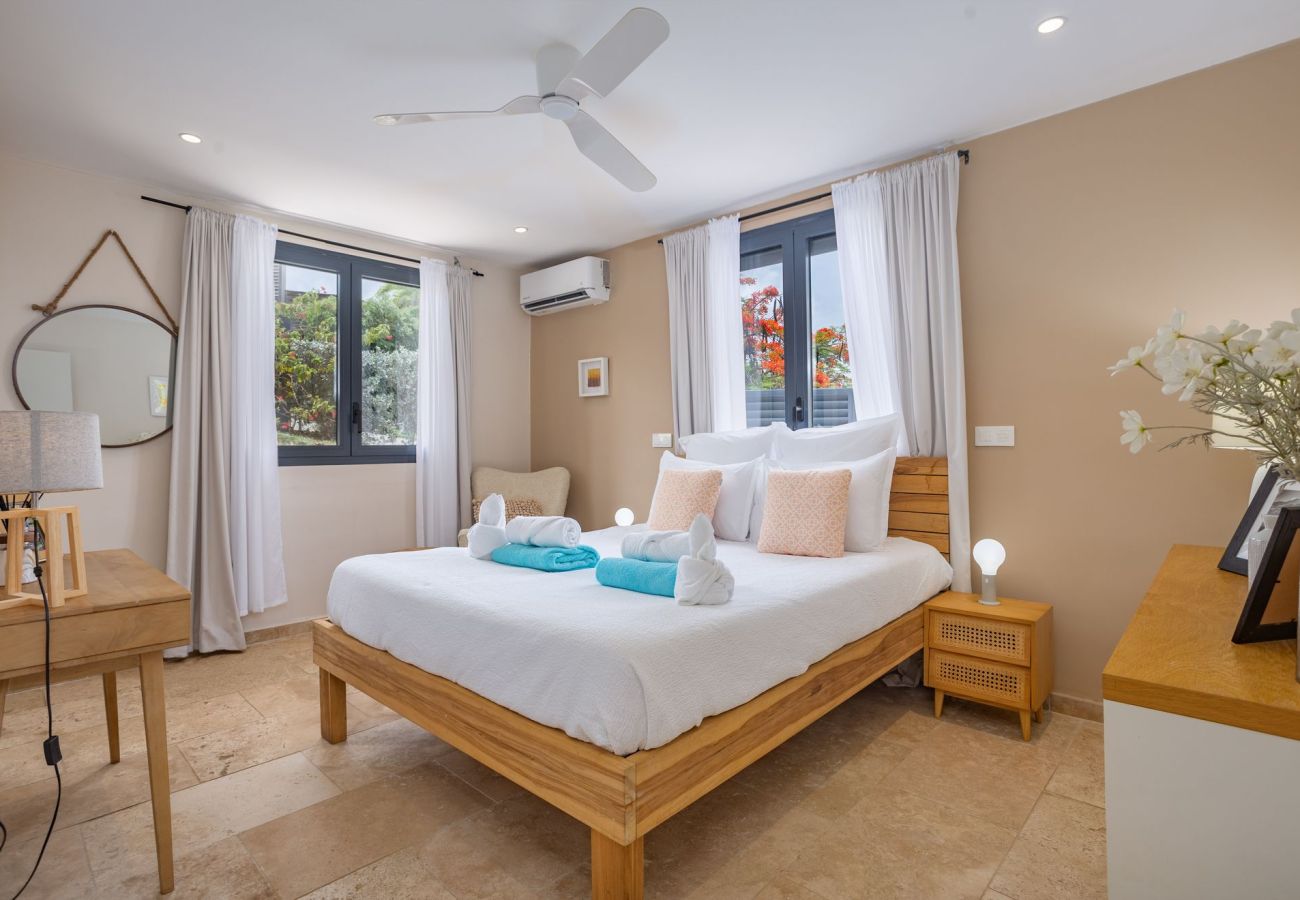 Air-conditioned master bedroom with private bathroom at Villa Bohème, Cap Est, Le François, Martinique.
