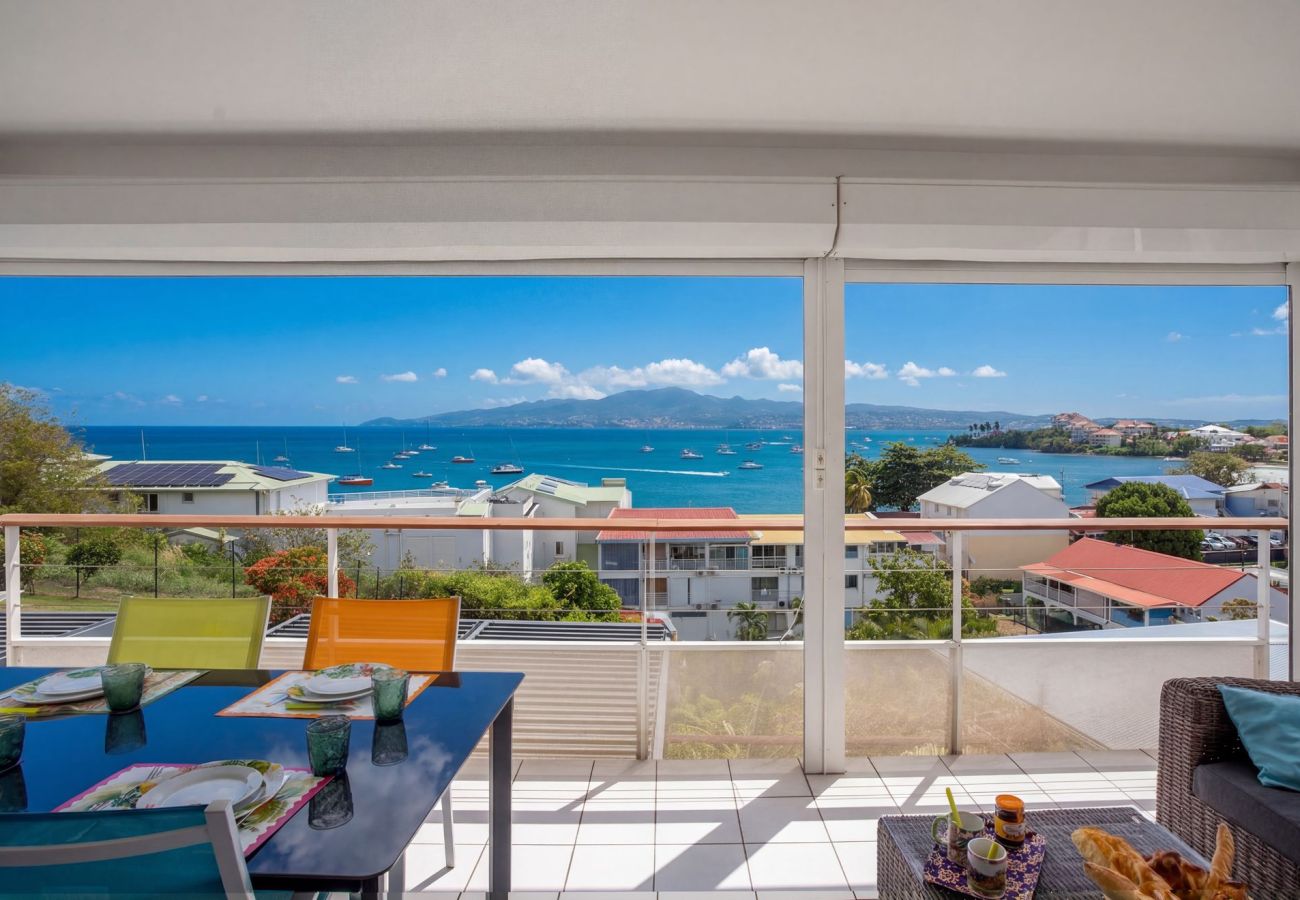 Panoramic view from Ti'Bato Apartment terrace overlooking Fort-de-France Bay in Les Trois-Îlets, Martinique.