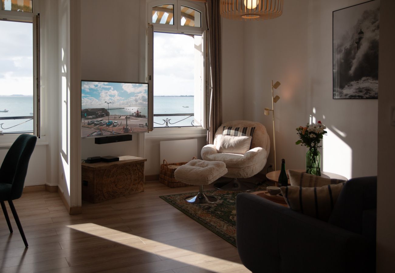 A bright living room with views of the sea and La Houle harbour in Cancale
